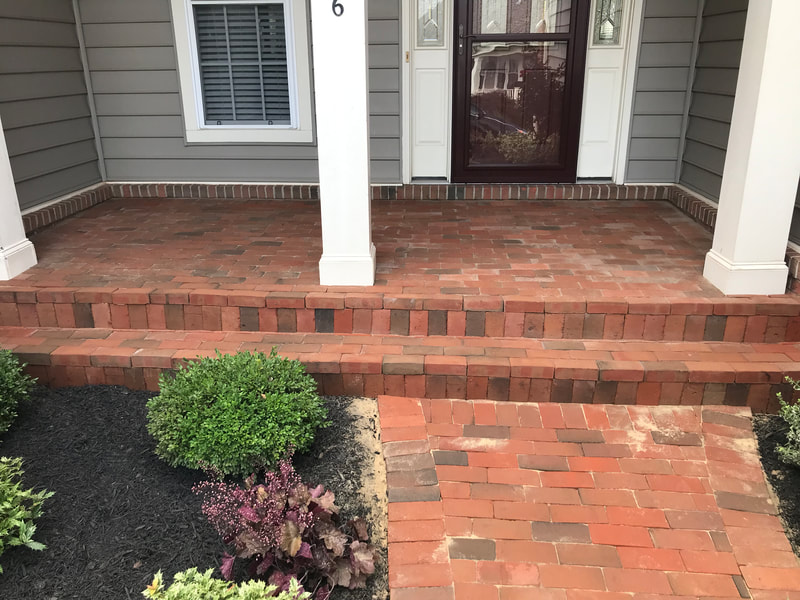 Brick stoop with walkway and steps. 
