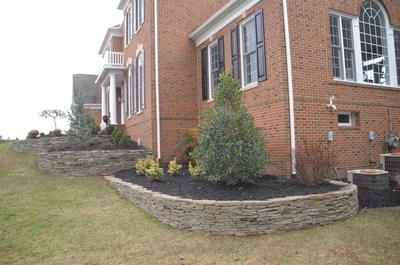 Stacked fieldstone walls with raised beds. 