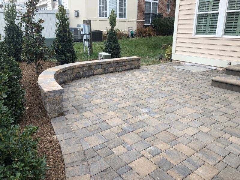 Paver patio with bullnose patio door steps and paver wallstone seating wall. 