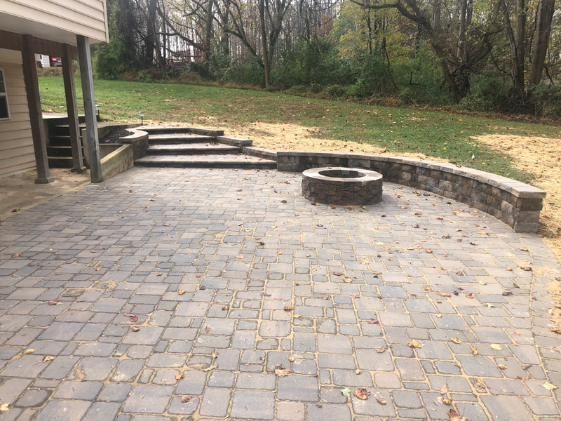 Paver patio with seating wall and firepit. 