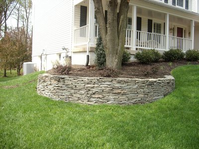 Stacked fieldstone retaining walls with raised beds.  