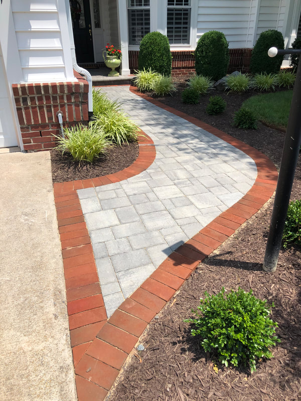 Paver walkway with brick soldier course from driveway to front door. 