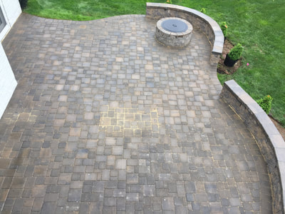 Paver patio with paver seating walls and permanent wallstone firepit. 