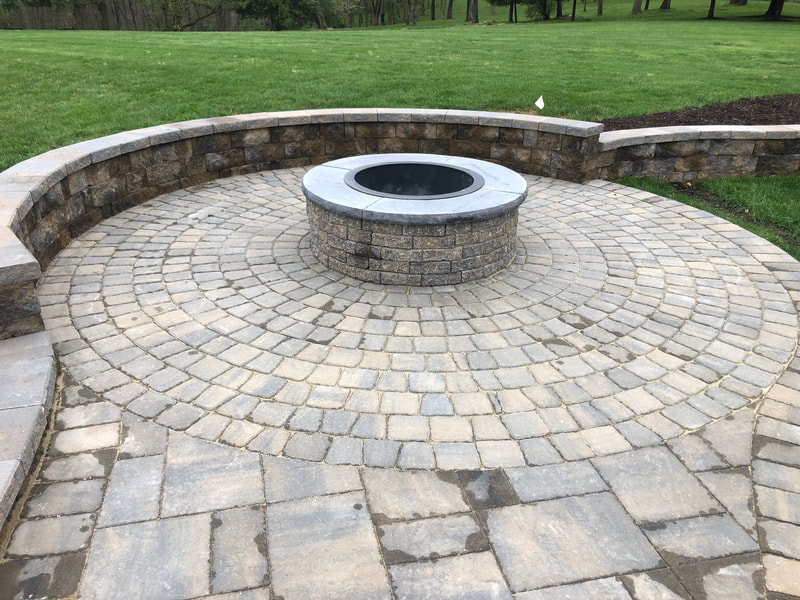 Circle Kit paver patio with wallstone firepit.  Paver wallstone seating wall and steps. 