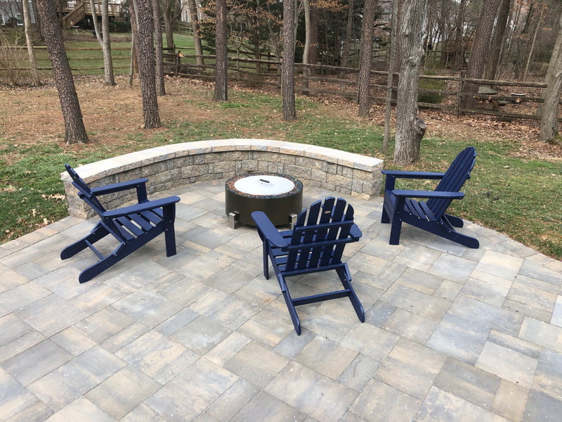 Paver patio with seating wall.  Space for a portable fire pit. 