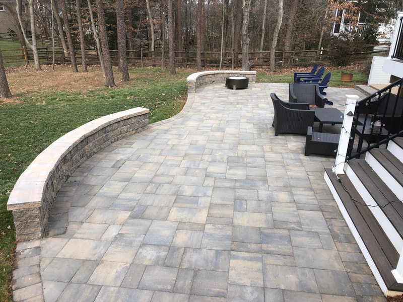 Paver patio with wallstone seating wall and capstone. 