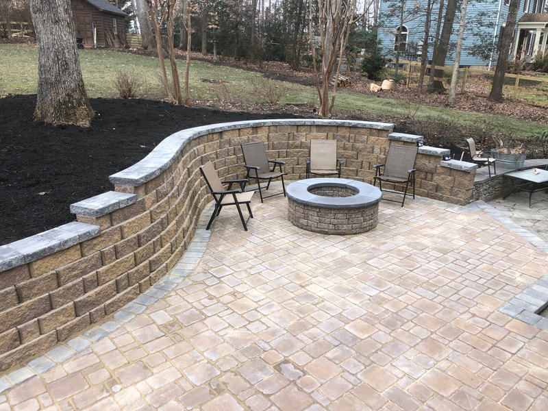 Paver retaining wall system and paver patio. Paver firepit with capstone and metal insert. 