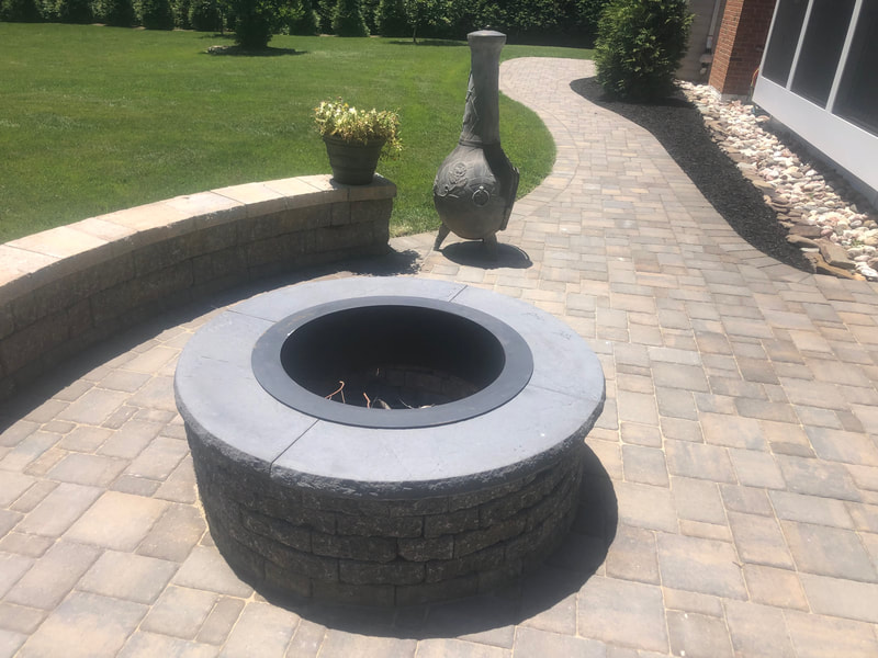 Paver walkway, paver seating wall, drainage swale and permanent fire pit. 