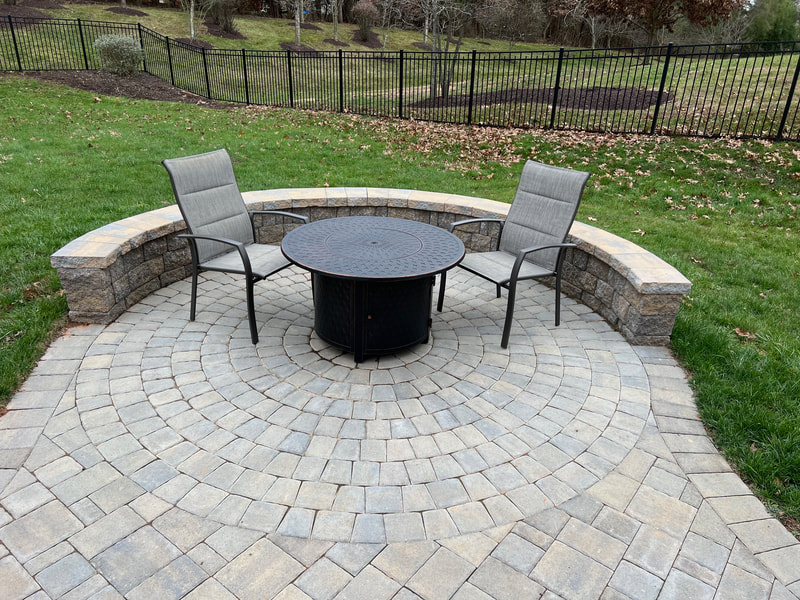 Circle Kit paver patio with seating wall. 
