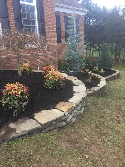 Drystacked fieldstone walls with raised beds. 
