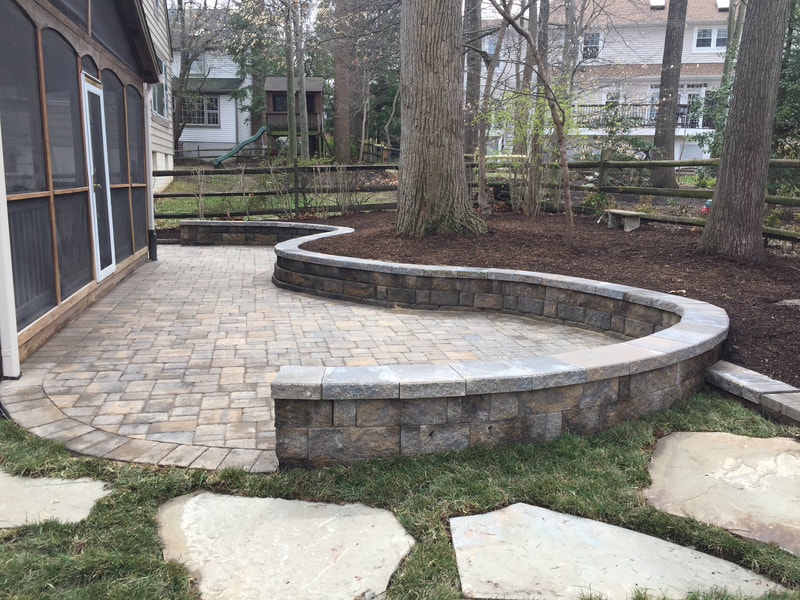 Paver patio with retaining/seating wall with capstone. 