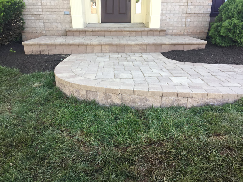 Paver walkway with footer wall and paver stoop with bullnose steps. 
