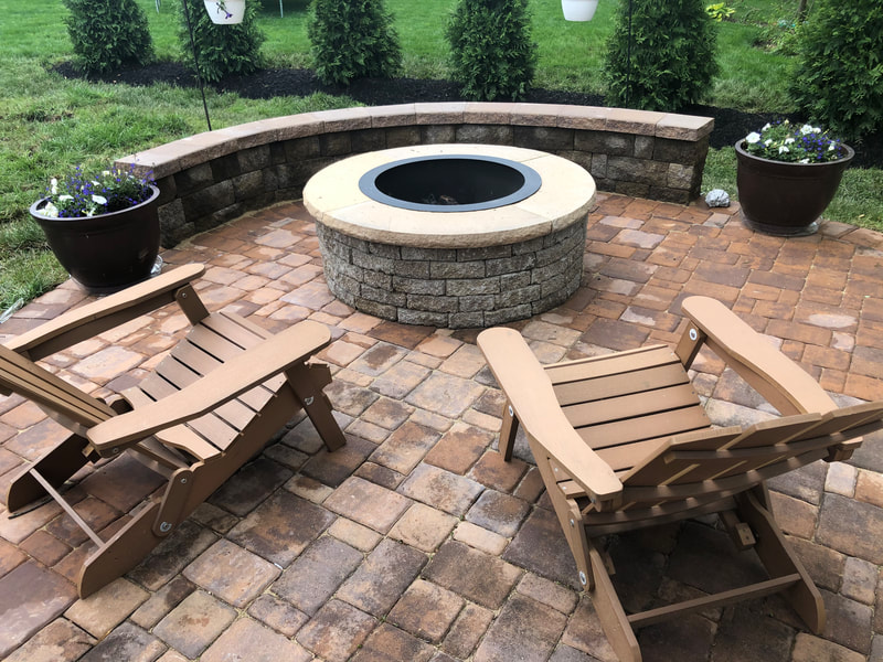 Paver patio.  Adirondack chairs.  Permanent firepit.  Paver seating wall. 