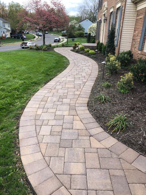 New curved paver walkway from the driveway to the front door. 