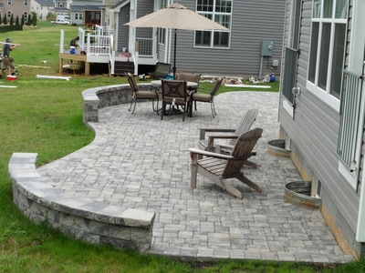 Paver patio with window wells.  Two seating walls. Paver color: Granite 