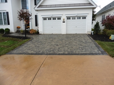 Paver driveway with charcoal soldier course that leads to the front door. 