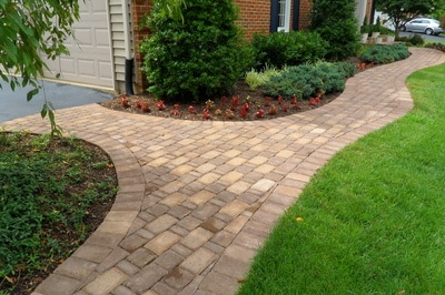 Curved paver walkway from driveway to front door. 
