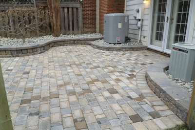 Paver patio with retaining walls and raised beds. 