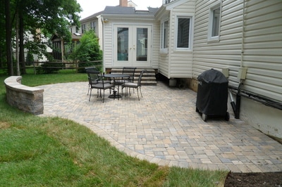 Paver patio with paver seating wall and capstone. 