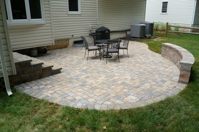 Paver patio with seating wall and deck steps with bullnose. 